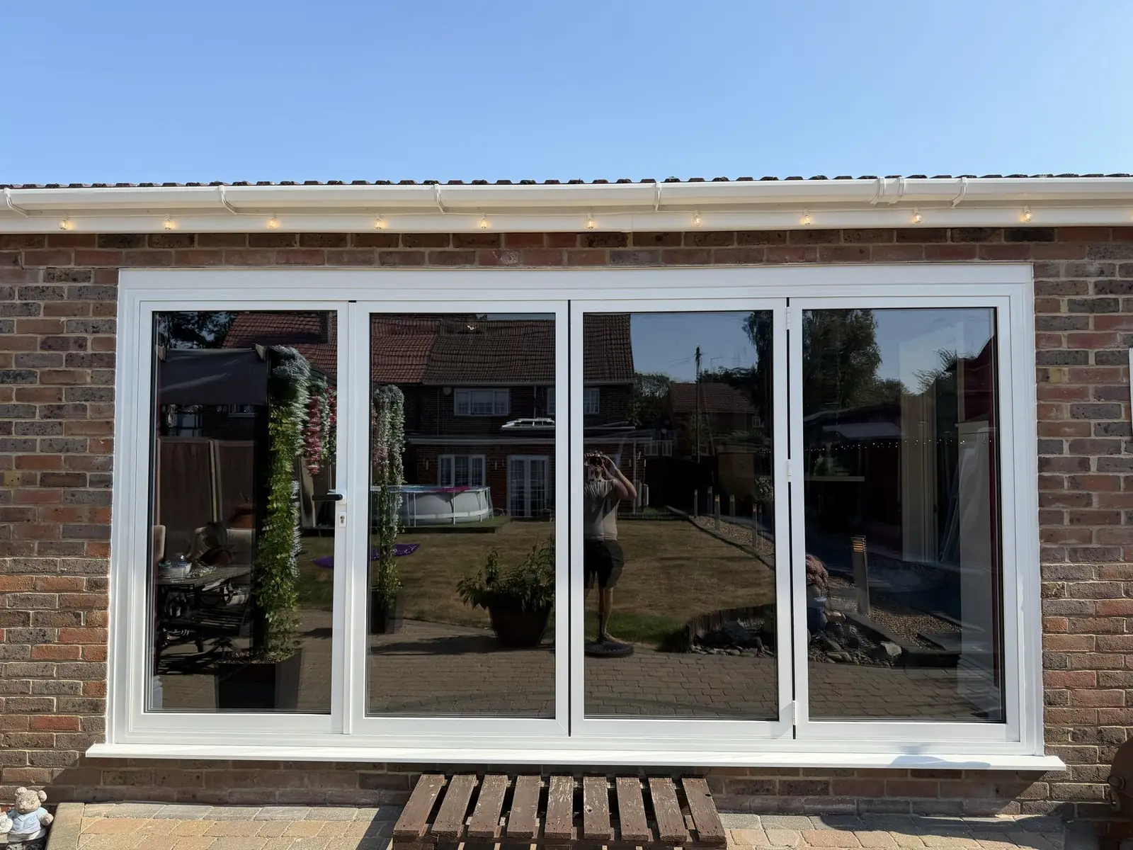 White uPVC bifold doors fitted to a bungalow